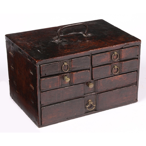 6 - AN UNUSUAL SMALL BOARDED OAK TABLE-TOP CHEST OF DRAWERS, ENGLISH, CIRCA 1700-20. With iron bale hand... 