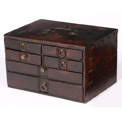 6 - AN UNUSUAL SMALL BOARDED OAK TABLE-TOP CHEST OF DRAWERS, ENGLISH, CIRCA 1700-20. With iron bale hand... 