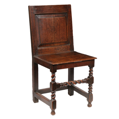 61 - AN UNCOMMON CHARLES II OAK BACKSTOOL, CIRCA 1680. Having a fully enclosed back, with fielded panel, ... 