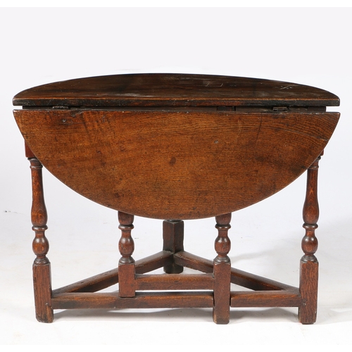 62 - AN RARE WILLIAM & MARY OAK SINGLE DROP-LEAF TABLE, CIRCA 1690. Having a demi-lune top, and triangula... 