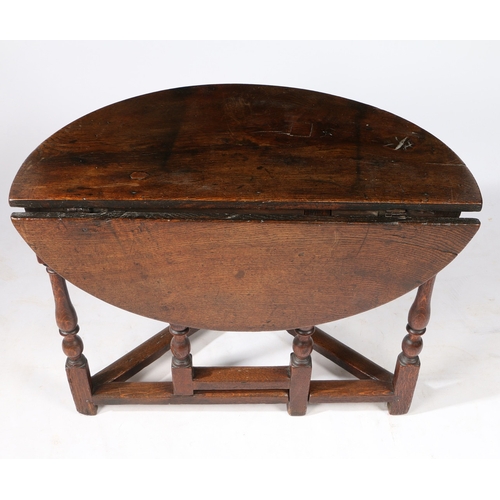 62 - AN RARE WILLIAM & MARY OAK SINGLE DROP-LEAF TABLE, CIRCA 1690. Having a demi-lune top, and triangula... 