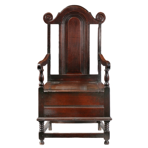 7 - AN UNUSUAL WILLIAM & MARY OAK BOX-SEATED ARMCHAIR, CIRCA 1690. The back part open and with a fielded... 