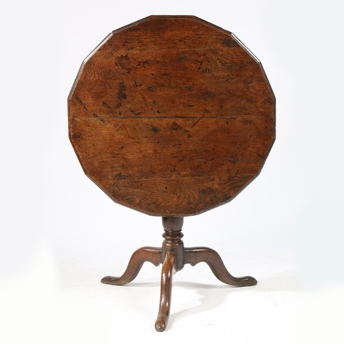 76 - A RARE GEORGE II OAK MULTI-SIDED TRIPOD SUPPER TABLE, CIRCA 1740. Having a round, sixteen-sided and ... 