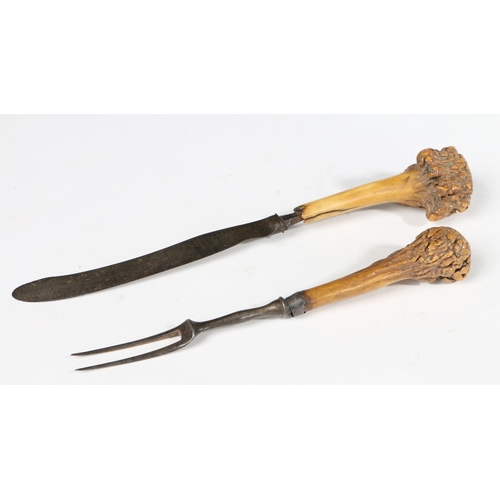 82 - A GEORGE II IRON AND ANTLER KNIFE AND FORK, CIRCA 1750. The fork with two tines, the knife with bowe... 