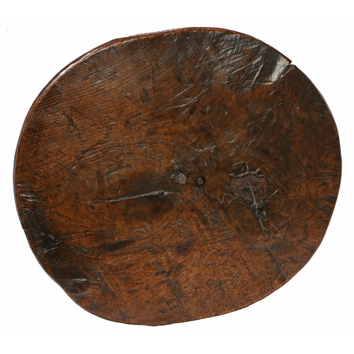 9 - A CHARMING GEORGE III OAK AND ASH PRIMITIVE CRICKET TABLE, CIRCA 1800. Having a one-piece oval top, ... 