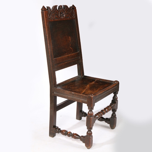 99 - A CHARLES II OAK BACKSTOOL, LANCASHIRE, CIRCA 1670. Having a plain back panel, a scroll-profiled and... 