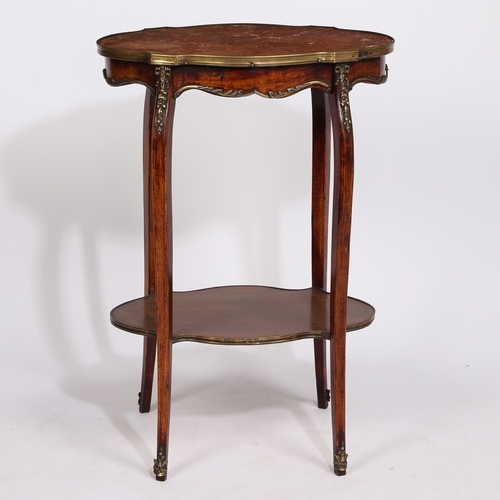 11 - A 19TH CENTURY FRENCH MARBLE TOPPED TWO TIER TABLE. having a shaped rouge marble top with a brass ed... 