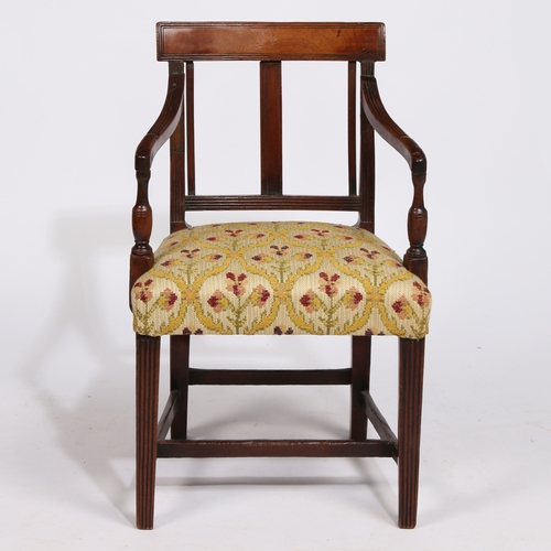 18 - A REGENCY MAHOGANY CHILDS ARMCHAIR. having a horizontal splat back raised on reeded arms on a uphols... 