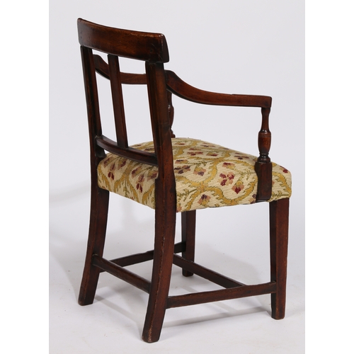 18 - A REGENCY MAHOGANY CHILDS ARMCHAIR. having a horizontal splat back raised on reeded arms on a uphols... 