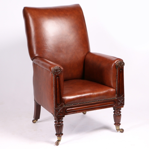 24 - A 19TH CENTURY LEATHER UPHOLSTERED ARMCHAIR. having an upholstered back and arms with floral carved ... 