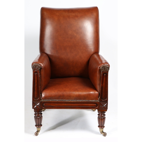 24 - A 19TH CENTURY LEATHER UPHOLSTERED ARMCHAIR. having an upholstered back and arms with floral carved ... 