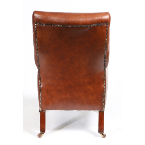 24 - A 19TH CENTURY LEATHER UPHOLSTERED ARMCHAIR. having an upholstered back and arms with floral carved ... 