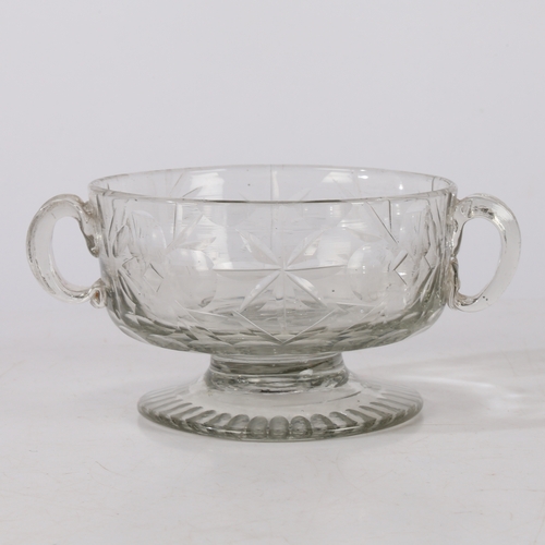 261 - A MID 18TH CENTURY BOHEMIAN CUT GLASS DISH. Circa 1740, having twin handles above a star and circle ... 