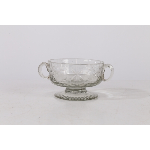 261 - A MID 18TH CENTURY BOHEMIAN CUT GLASS DISH. Circa 1740, having twin handles above a star and circle ... 