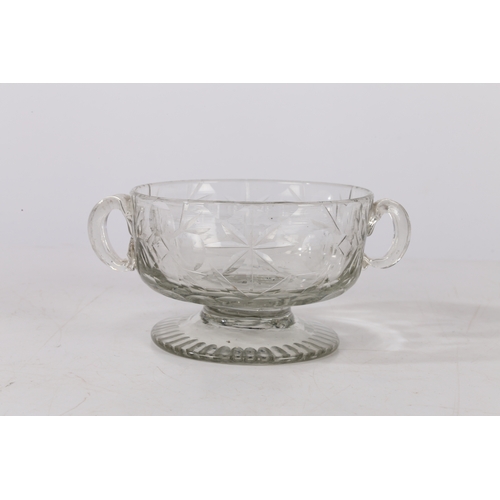 261 - A MID 18TH CENTURY BOHEMIAN CUT GLASS DISH. Circa 1740, having twin handles above a star and circle ... 