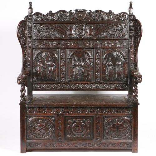 31 - A 19TH CENTURY OAK SETTLE IN THE 17TH CENTURY MANNER. having a scroll cresting rail with finials in ... 