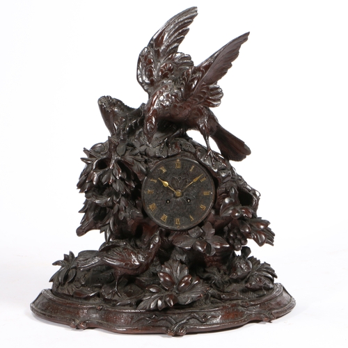 46 - A 19TH CENTURY BLACK FOREST LARGE NATURALISTICALLY CARVED MANTEL CLOCK. the case with a partridge fa... 