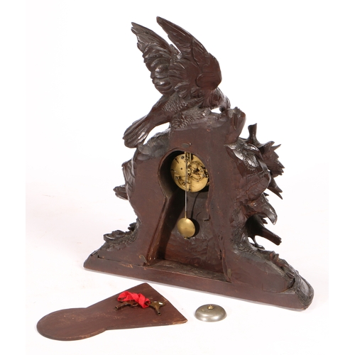 46 - A 19TH CENTURY BLACK FOREST LARGE NATURALISTICALLY CARVED MANTEL CLOCK. the case with a partridge fa... 