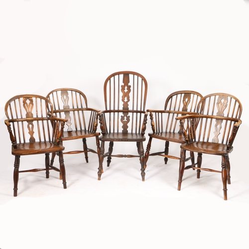 65 - A SET OF FIVE OAK AND ELM WINDSOR ARMCHAIRS. having an arched cresting rail above a pierced splat ba... 