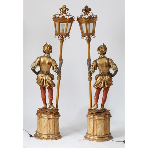 66 - A PAIR OF 20TH CENTURY BLACKAMOOR FLOOR LAMPS. resin figures mounted on plinth bases holding a lante... 