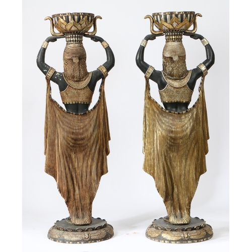 67 - A PAIR OF FLOOR STANDING PLANTERS MODELLED AS CLEOPATRA'S EGYPTIAN NUBIAN MAIDENS. life size resin f... 