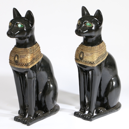 77 - A PAIR OF 20TH CENTURY RESIN EGYPTIAN CATS. painted in black with an Egyptian style design, 74cm hig... 