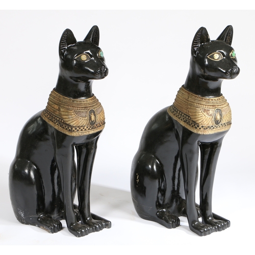 77 - A PAIR OF 20TH CENTURY RESIN EGYPTIAN CATS. painted in black with an Egyptian style design, 74cm hig... 
