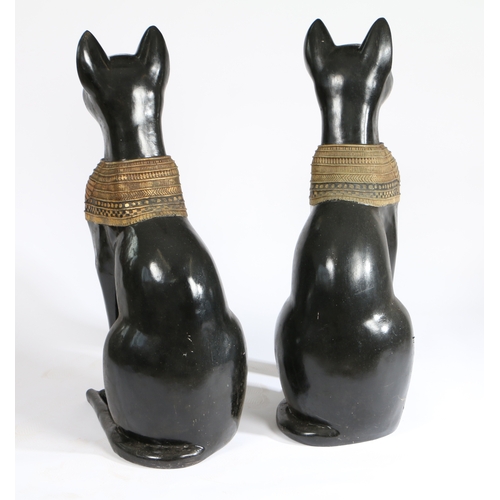 77 - A PAIR OF 20TH CENTURY RESIN EGYPTIAN CATS. painted in black with an Egyptian style design, 74cm hig... 