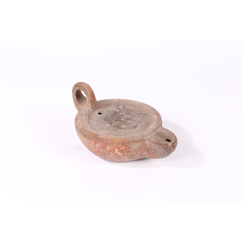 2 - A RARE OVERSIZED ROMAN OIL LAMP, 3RD CENTURY A.D. With the head of a Satyr to the centre and a loop ... 