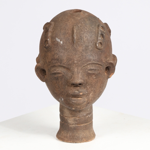 51 - AN AKAN NSODI CLAY POTTERY DOUBLE SIDED HEAD, GHANA. each face having ring decoration to the forehea... 