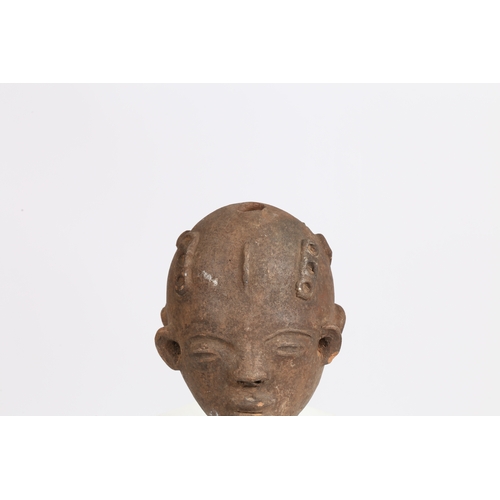 51 - AN AKAN NSODI CLAY POTTERY DOUBLE SIDED HEAD, GHANA. each face having ring decoration to the forehea... 