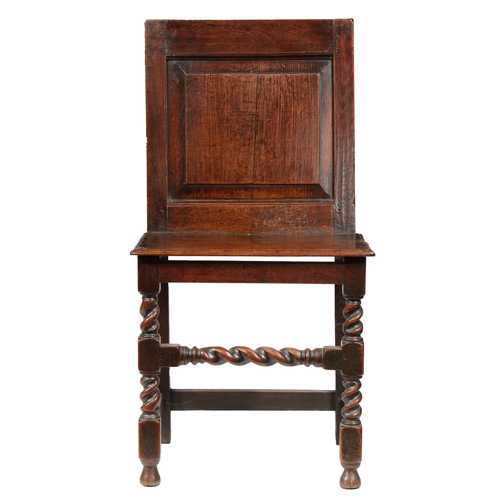 11 - AN UNCOMMON CHARLES II OAK BACKSTOOL, CIRCA 1680. Having a fully enclosed back, with fielded panel, ... 