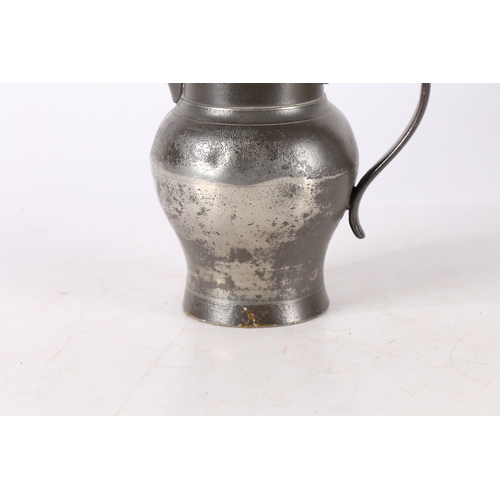 123 - A GEORGE III PEWTER QUART ALE JUG, CIRCA 1800. The body of ovoid form, with tall cylindrical collar ... 