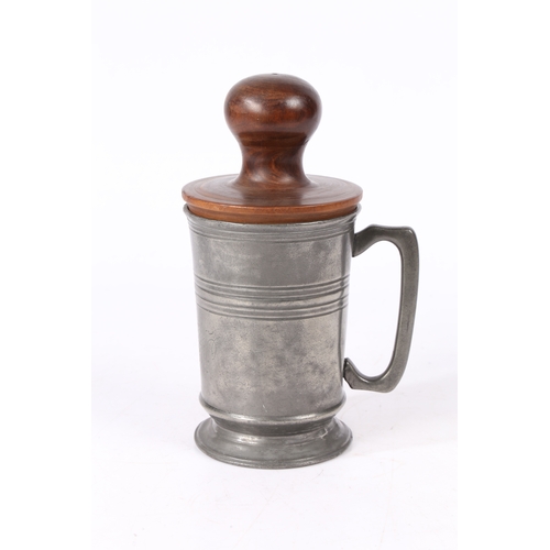 153 - AN EARLY 19TH CENTURY LIGNUM VITAE 'FORMER OR JACK AND A PEWTER QUART MUG. The straight-sided mug w... 