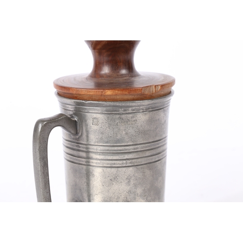 153 - AN EARLY 19TH CENTURY LIGNUM VITAE 'FORMER OR JACK AND A PEWTER QUART MUG. The straight-sided mug w... 