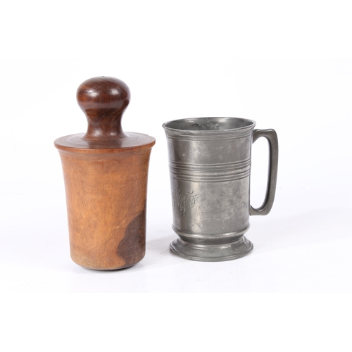 153 - AN EARLY 19TH CENTURY LIGNUM VITAE 'FORMER OR JACK AND A PEWTER QUART MUG. The straight-sided mug w... 