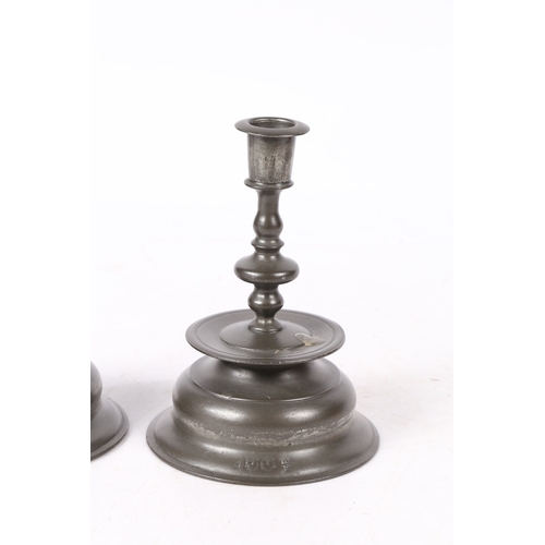 158 - A PAIR OF PEWTER LOW BELL CANDLESTICKS, IN THE 17TH CENTURY BRASS NUREMBERG MANNER. Each baluster ... 