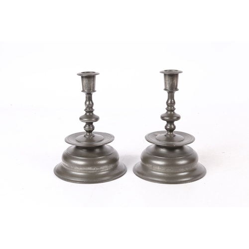 158 - A PAIR OF PEWTER LOW BELL CANDLESTICKS, IN THE 17TH CENTURY BRASS NUREMBERG MANNER. Each baluster ... 