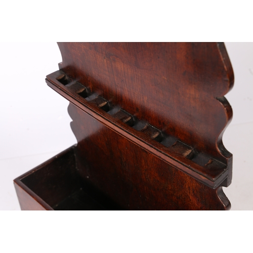 16 - A GEORGE III OAK SPOON RACK, CIRCA 1800. The one-piece back board with arch-shaped cresting and ogee... 