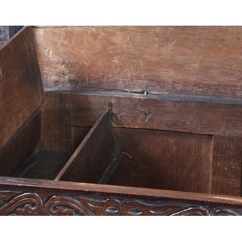 165 - A CHARLES II OAK COFFER, WEST COUNTRY. CIRCA 1670. Having a twin boarded top, the front of three pan... 