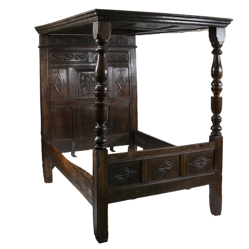 170 - CHARLES II OAK TESTER BED, LANCASHIRE, CIRCA 1670 AND LATER. Having a nine carved-panelled canopy, t... 