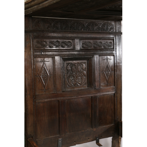 170 - CHARLES II OAK TESTER BED, LANCASHIRE, CIRCA 1670 AND LATER. Having a nine carved-panelled canopy, t... 