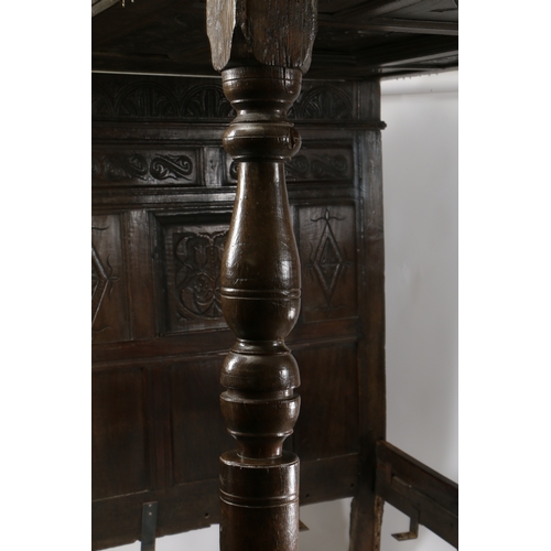 170 - CHARLES II OAK TESTER BED, LANCASHIRE, CIRCA 1670 AND LATER. Having a nine carved-panelled canopy, t... 