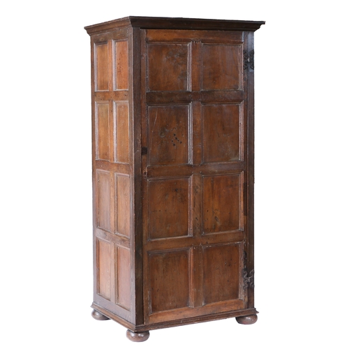 172 - AN OAK LIVERY CUPBOARD. Constructed from 17th/18th century panelling, having a single eight-panelled... 