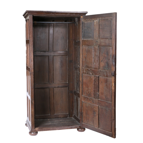 172 - AN OAK LIVERY CUPBOARD. Constructed from 17th/18th century panelling, having a single eight-panelled... 