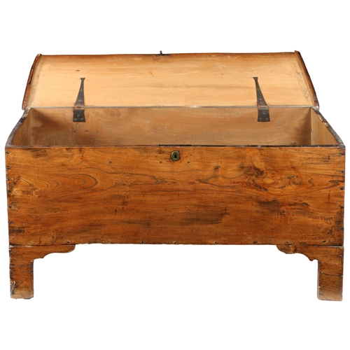 173 - AN EARLY 18TH CENTURY ELM BOARDED CHEST. The one-piece lid with moulded edge, the sides descending t... 