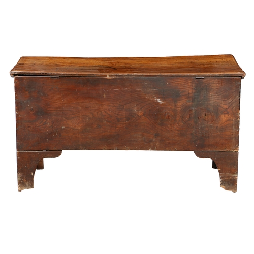 173 - AN EARLY 18TH CENTURY ELM BOARDED CHEST. The one-piece lid with moulded edge, the sides descending t... 