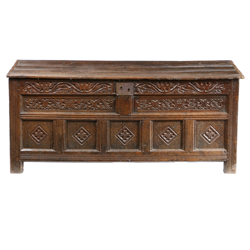 174 - A CHARLES II OAK COFFER, WESTMORLAND, CIRCA 1660. Having an end-cleated boarded hinged lid, the fron... 