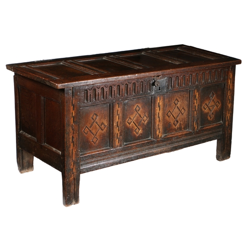 176 - A JAMES I OAK AND INLAID COFFER, CIRCA 1620. Having a quadruple-panelled lid, the front again with f... 