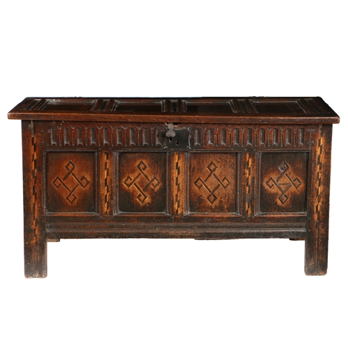 176 - A JAMES I OAK AND INLAID COFFER, CIRCA 1620. Having a quadruple-panelled lid, the front again with f... 